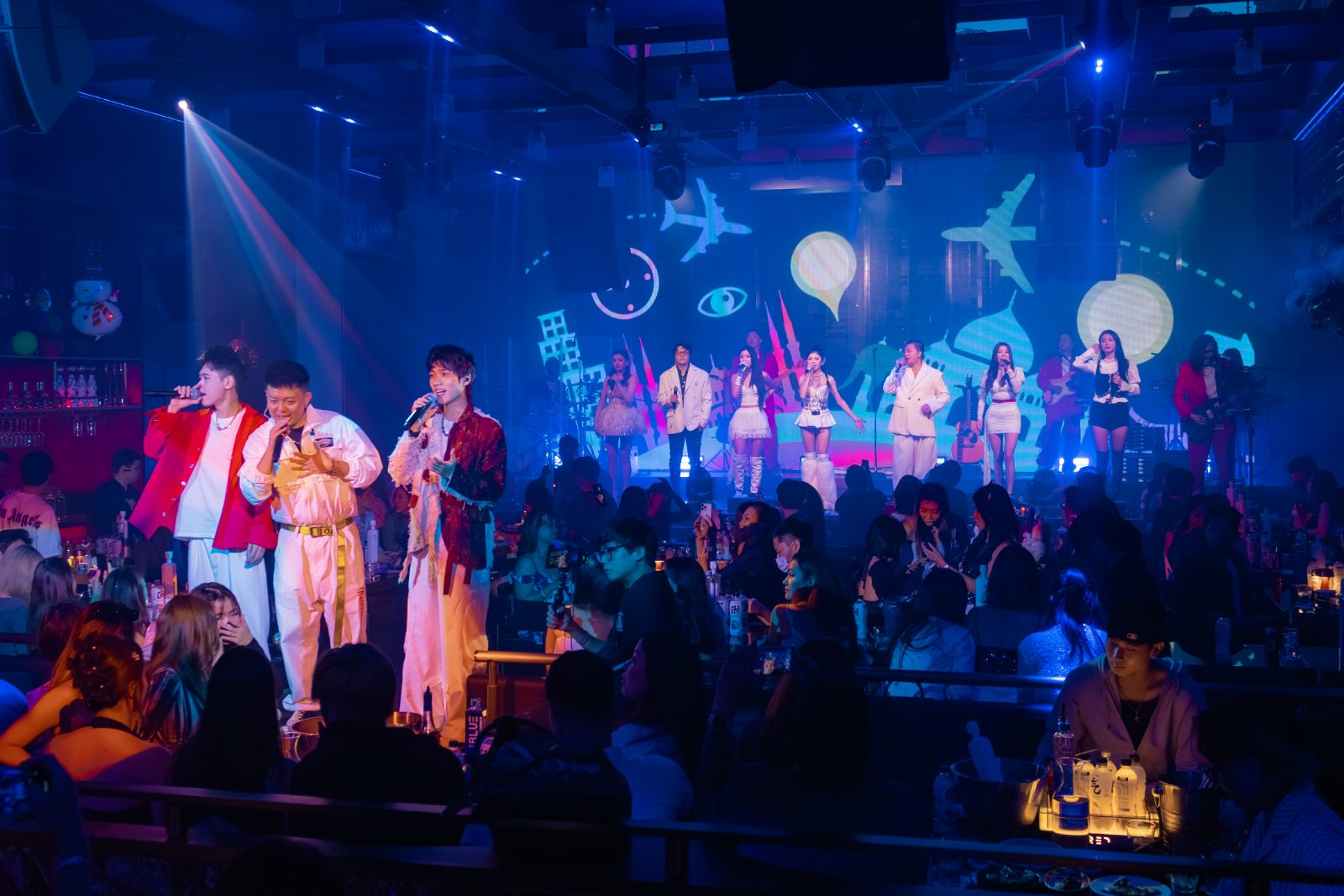 Performers on stage in blue light